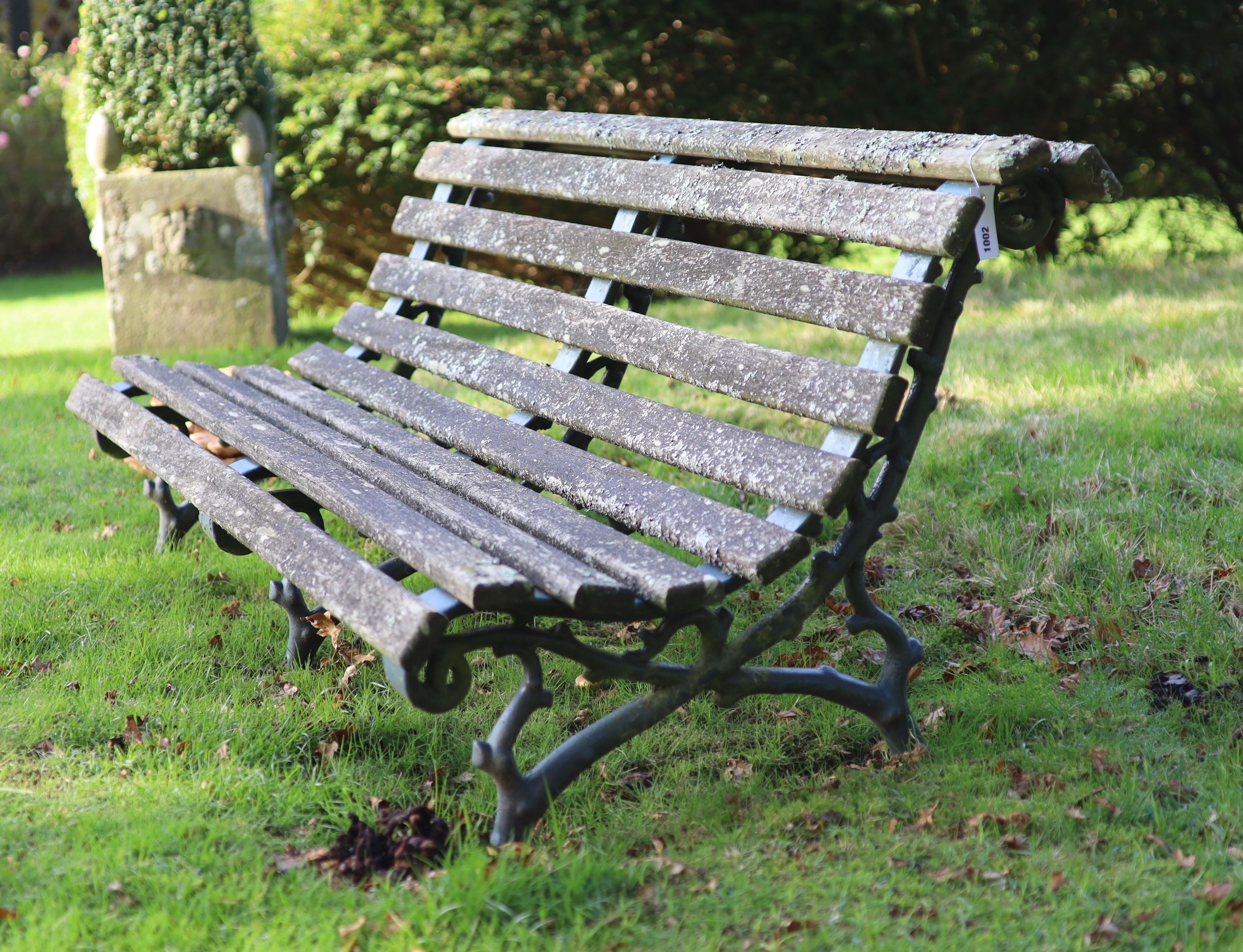 A pair of Coalbrookdale style cast iron and slatted teak garden benches, width 165cm depth 77cm height 60cm